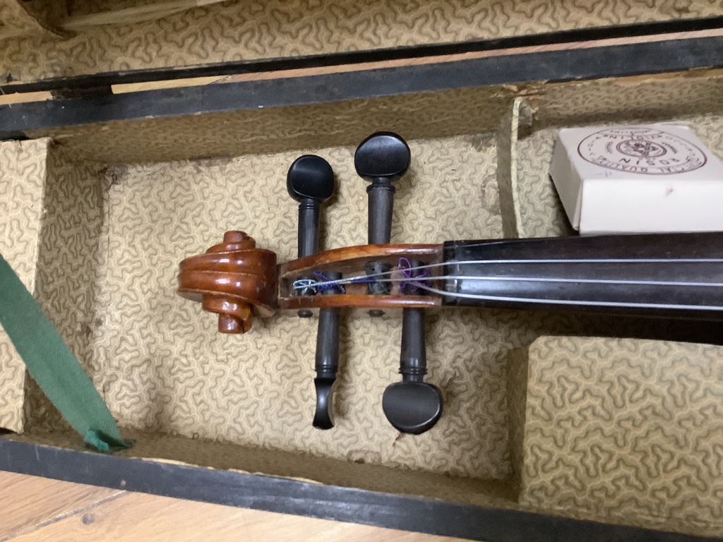 A violin and bow, in case, label to interior read Antonius Stadivarius Cremonensis, made in Czechoslovakia